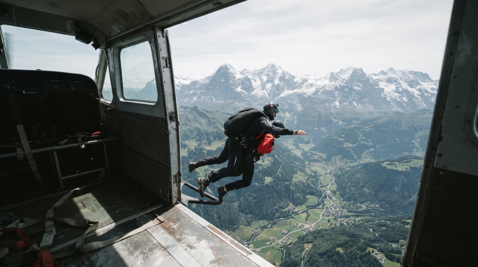 Tandem skydivers freefalling above the Swiss Alps near the Lauterbrunnen valley
