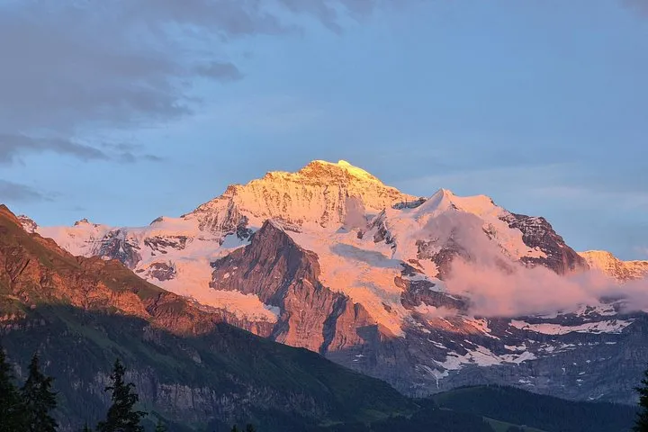 Hikers watching sunset over the Jungfrau from a trail above Wengen near Lauterbrunnen