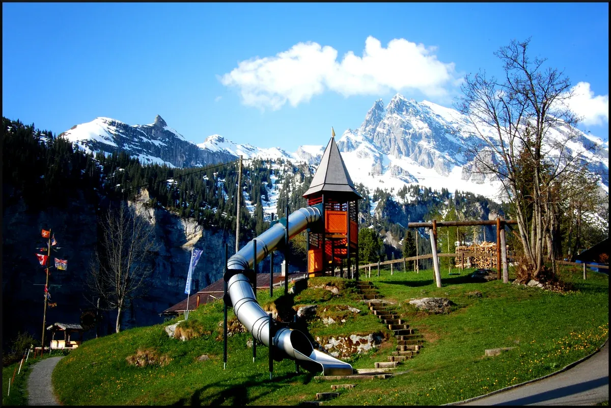 Gimmelwald on its slope below Mürren with the peaks across the Lauterbrunnen valley, Switzerland