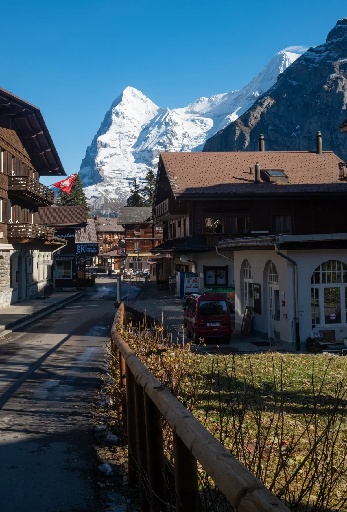 A street of timber chalets in car-free Mürren with the Eiger behind, above the Lauterbrunnen valley, Switzerland