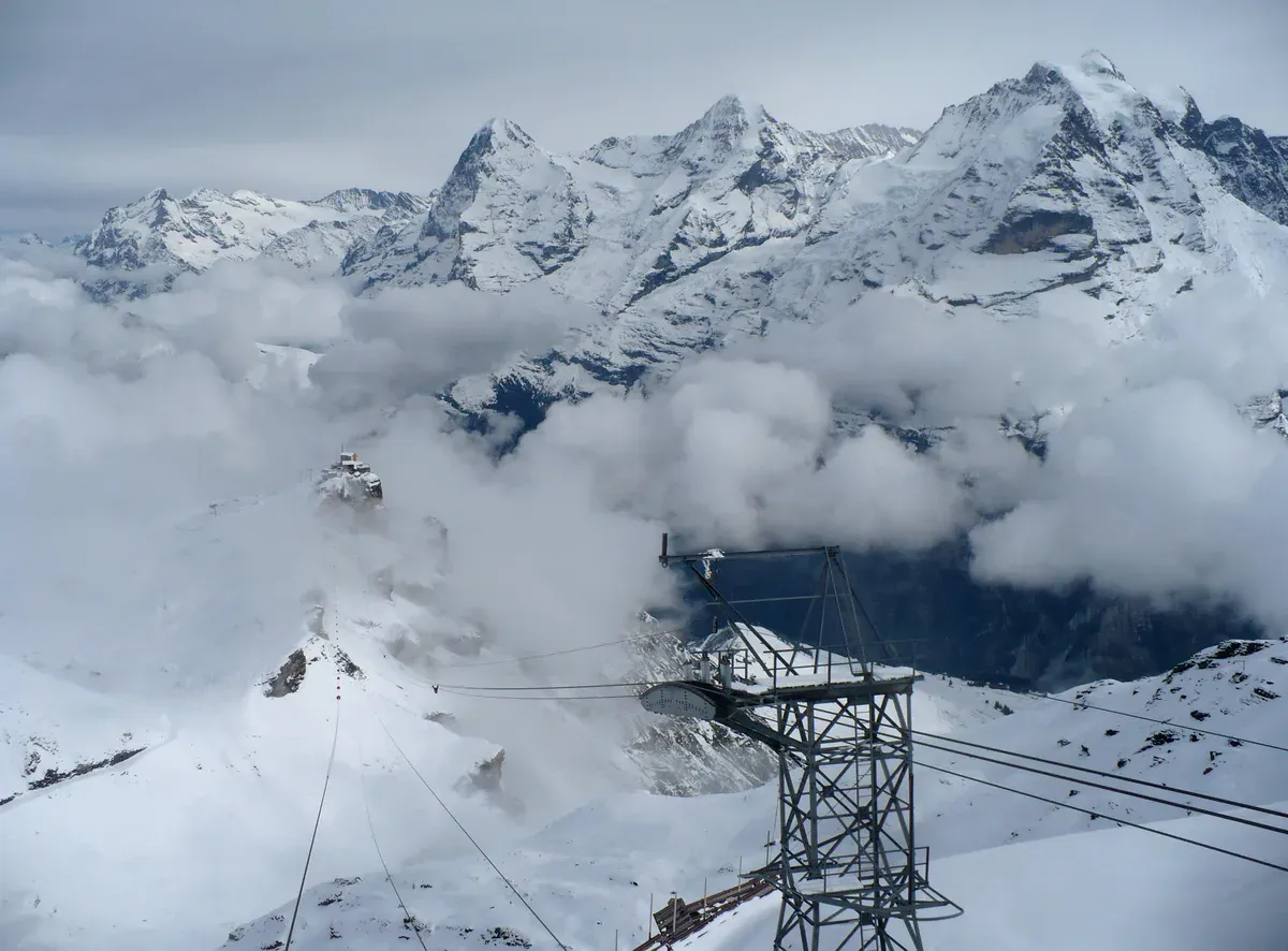 The Birg cable car station and tower on the Schilthorn cableway with the Eiger, Mönch and Jungfrau above the Lauterbrunnen valley, Switzerland