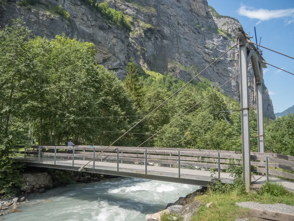 A footbridge over the Weisse Lütschine river near the Schilthorn cableway station in Stechelberg, Switzerland
