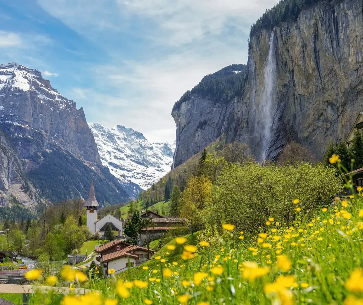 Lauterbrunnen village with the church and Staubbach Falls, a base for where to stay in the Lauterbrunnen valley